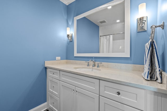 bathroom featuring curtained shower, baseboards, visible vents, and vanity