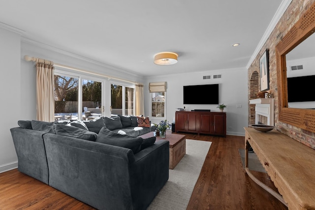 living area with plenty of natural light, crown molding, and wood finished floors