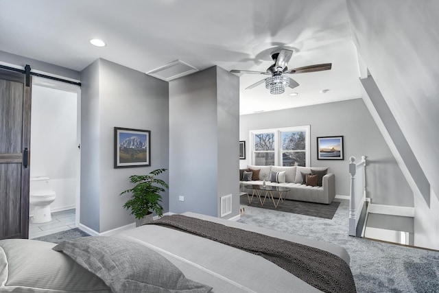 carpeted bedroom with a barn door, recessed lighting, visible vents, baseboards, and attic access