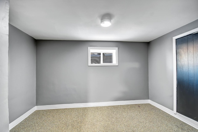 unfurnished room with baseboards and carpet flooring