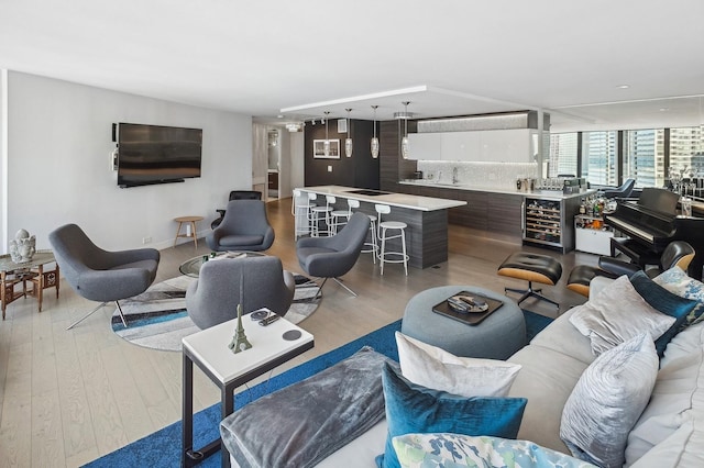 living room with light wood-style floors and beverage cooler