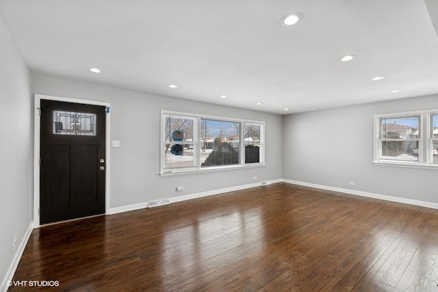 foyer with recessed lighting, dark wood-style flooring, visible vents, and baseboards