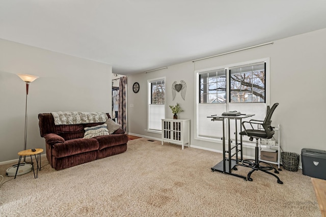 carpeted living area with baseboards