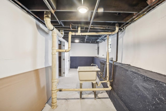unfinished basement featuring a sink