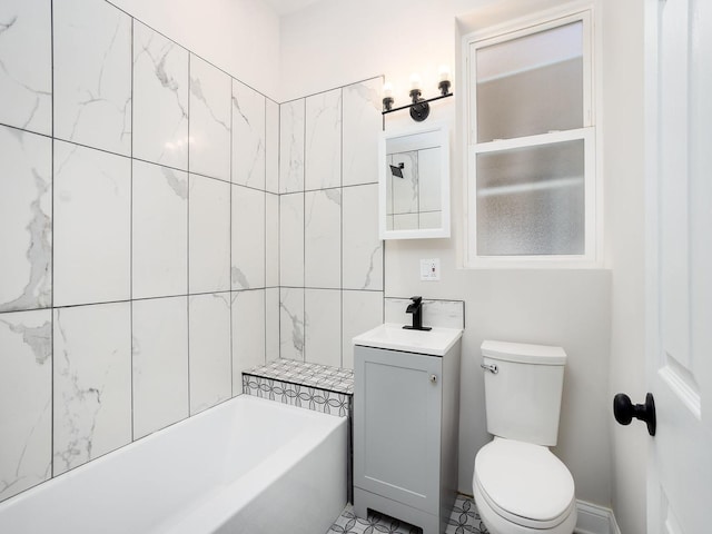 bathroom with toilet, vanity, and a bathtub