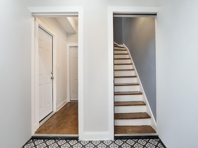 stairs featuring baseboards and wood finished floors