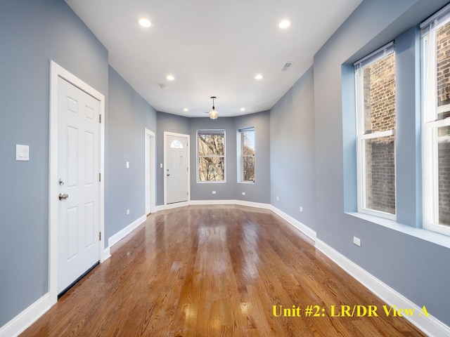 spare room featuring light wood-style flooring, visible vents, baseboards, and recessed lighting