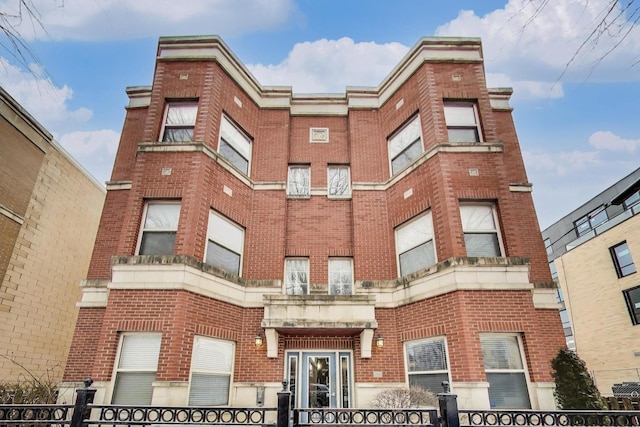 view of building exterior featuring a fenced front yard