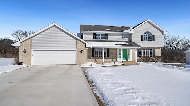 traditional-style home featuring concrete driveway, brick siding, and an attached garage