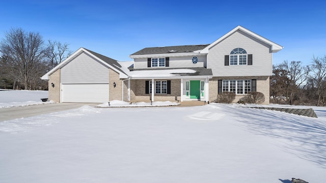 traditional home with brick siding and an attached garage