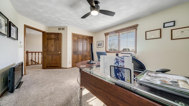 carpeted home office with visible vents and a ceiling fan