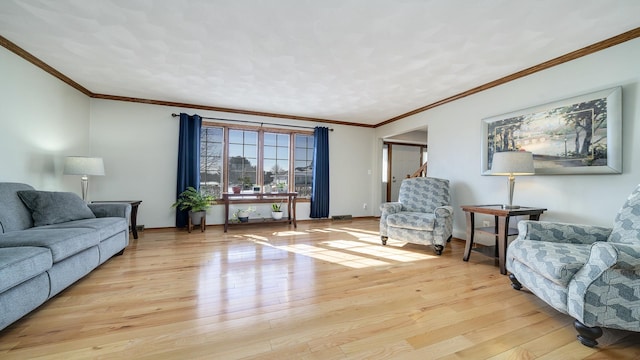 living room featuring light wood-style floors, crown molding, and baseboards