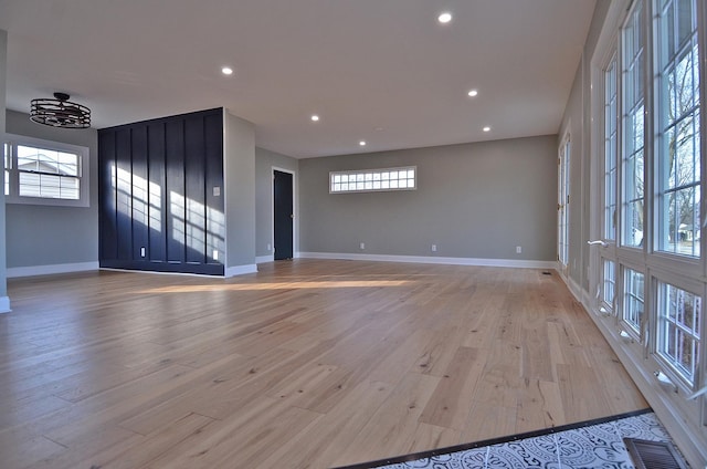 unfurnished room with light wood-style floors, baseboards, visible vents, and recessed lighting