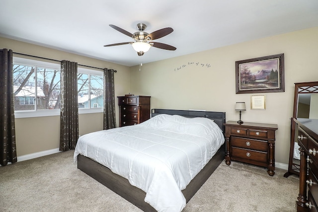 carpeted bedroom featuring a ceiling fan and baseboards