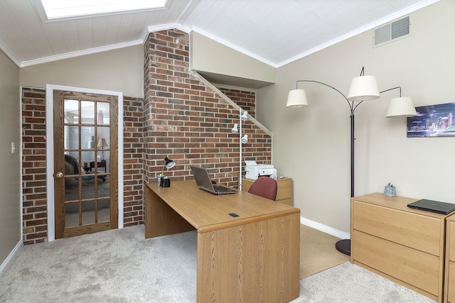 carpeted home office with visible vents, brick wall, baseboards, vaulted ceiling, and crown molding