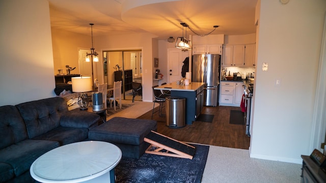 living room with a chandelier and baseboards