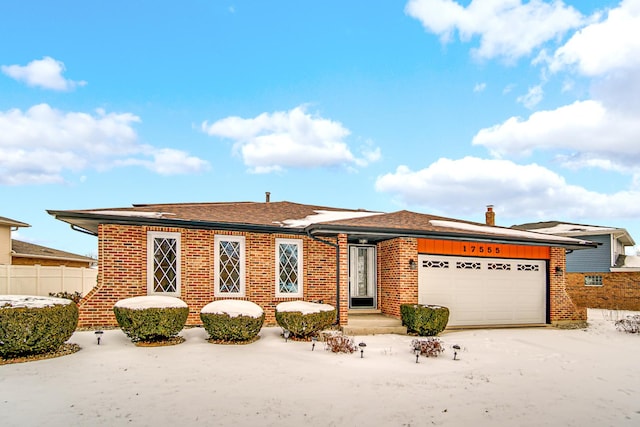 ranch-style home with a garage, brick siding, a chimney, and fence