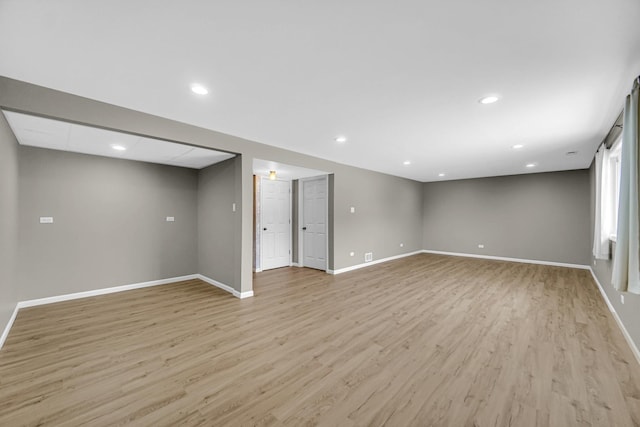 interior space with light wood finished floors, baseboards, and recessed lighting