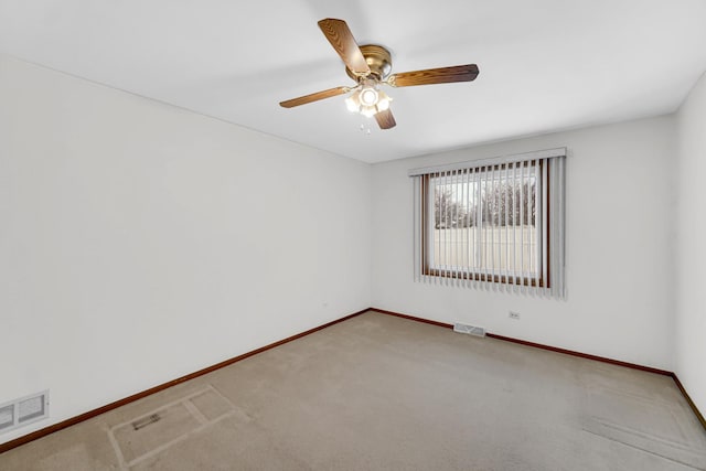 unfurnished room with carpet, baseboards, visible vents, and ceiling fan