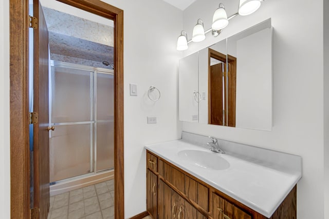 bathroom with a stall shower and vanity