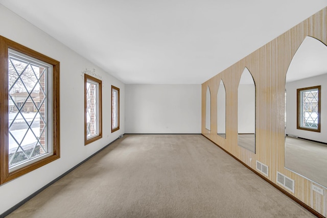 empty room featuring light colored carpet and visible vents