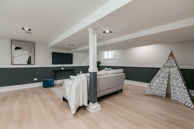 living area with light wood-style floors and baseboards