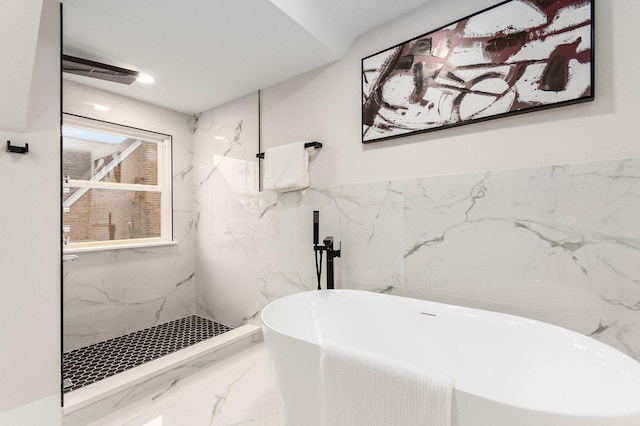 full bath featuring marble finish floor, a soaking tub, and walk in shower