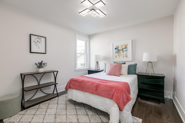 bedroom with baseboards and wood finished floors