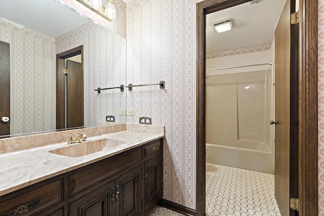 bathroom with tile patterned floors, bathtub / shower combination, vanity, and wallpapered walls