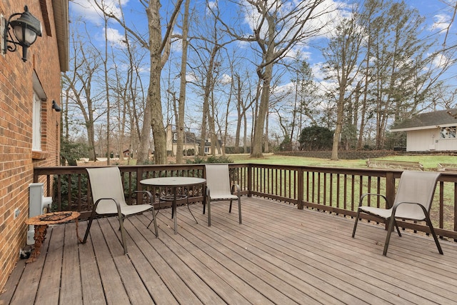 wooden deck featuring a lawn