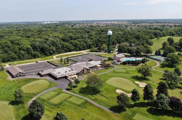 aerial view with view of golf course and a forest view