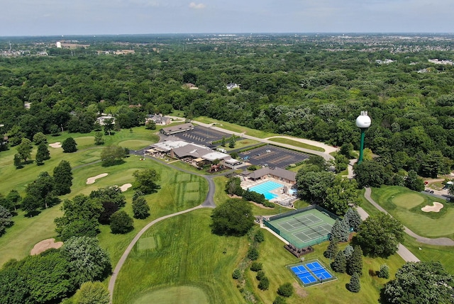 birds eye view of property with a forest view and golf course view