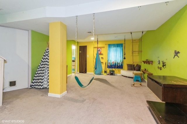 playroom featuring baseboards, visible vents, and light colored carpet