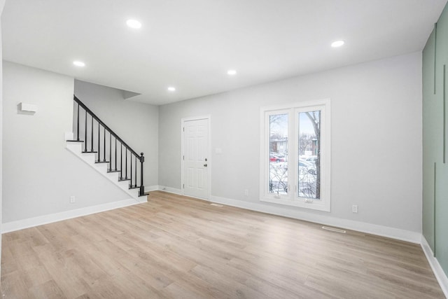 foyer with light wood-style flooring, stairs, baseboards, and recessed lighting