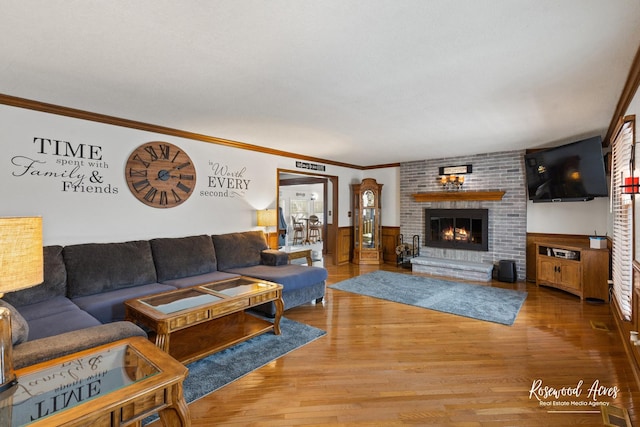 330 Fox Trl, Bourbonnais, IL 60914 - living area featuring wood finished floors, a fireplace, ornamental molding, and a wainscoted wall