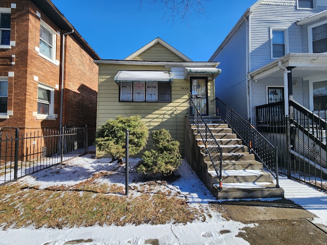 view of front of house with fence and stairway