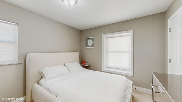 carpeted bedroom with baseboards