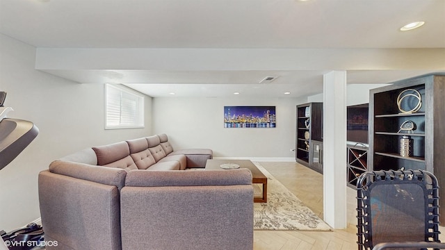 living area featuring baseboards and recessed lighting