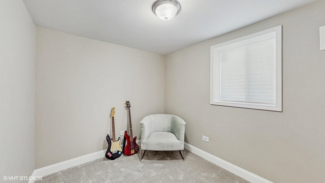 living area featuring carpet flooring and baseboards