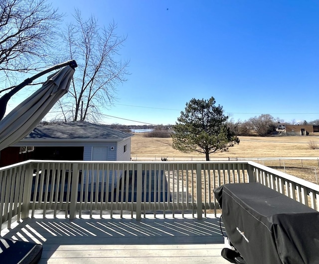 deck featuring grilling area and an outbuilding