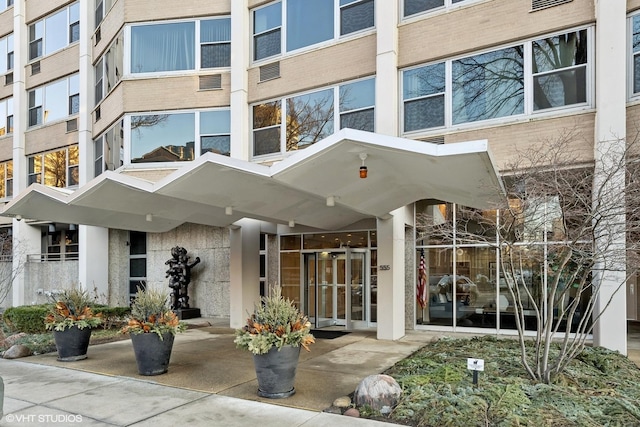 view of exterior entry with brick siding