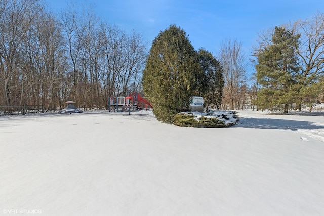 yard layered in snow featuring playground community