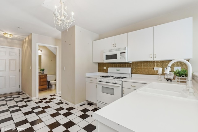 kitchen featuring light countertops, white appliances, white cabinetry, and tile patterned floors