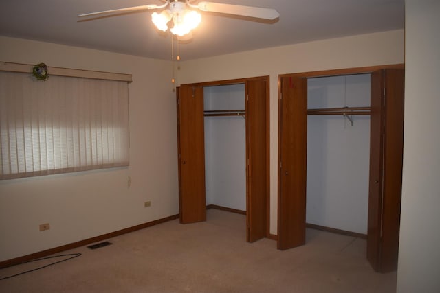 10600 Lynn Dr, Orland Park, IL 60467 - unfurnished bedroom featuring two closets, visible vents, a ceiling fan, light carpet, and baseboards