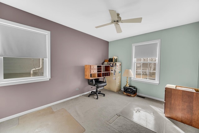 home office featuring carpet floors, ceiling fan, and baseboards