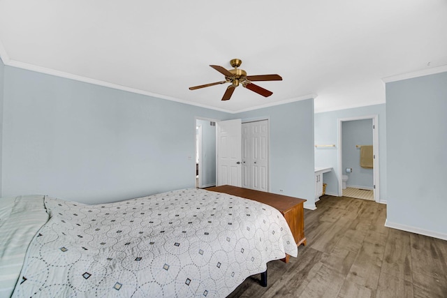 bedroom featuring baseboards, ornamental molding, and wood finished floors