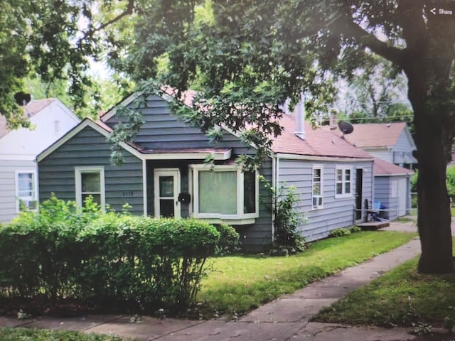 bungalow-style home featuring a front yard