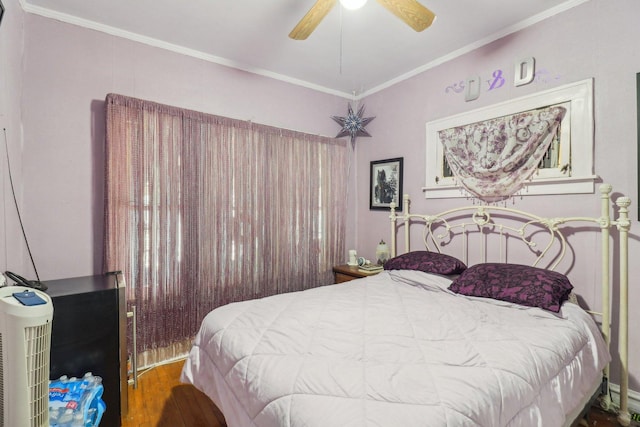 bedroom featuring ceiling fan, ornamental molding, and wood finished floors