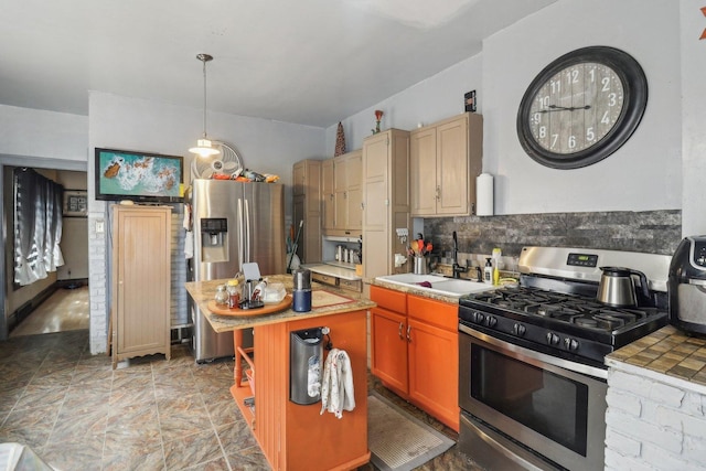 kitchen with a sink, a kitchen island, appliances with stainless steel finishes, tile counters, and decorative light fixtures