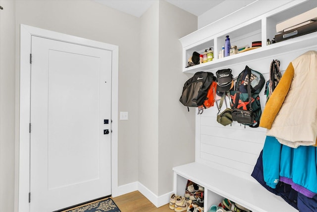 mudroom featuring baseboards and wood finished floors